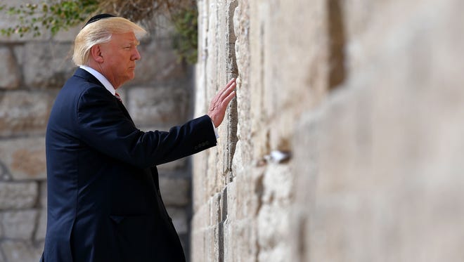 President Trump visits the Western Wall, the holiest site where Jews can pray, in Jerusalem's Old City Monday.
