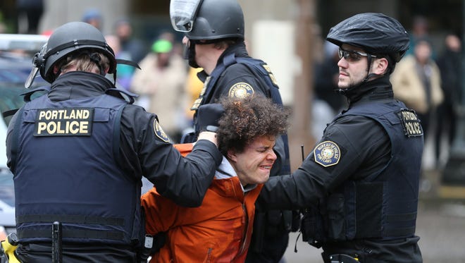 A person is detained during a protest on Feb. 20, 2017, in Portland, Ore.