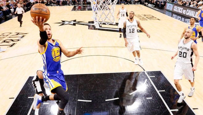 Golden State Warriors point guard Stephen Curry shoots the ball against the San Antonio Spurs during the first half in Game 4 of the Western Conference finals.