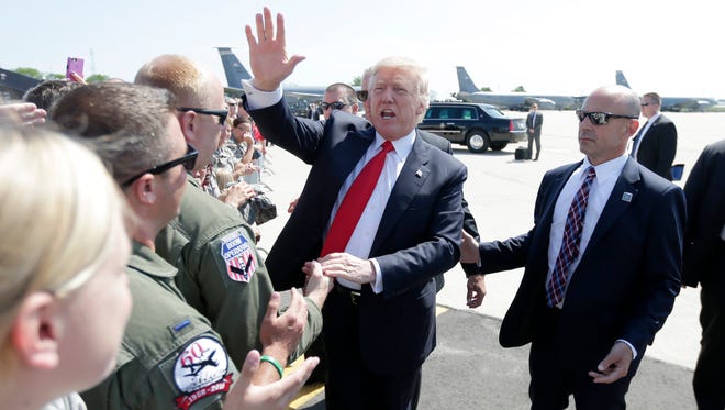 President Donald Trump waves to supporters at the 128th Air Refueling Wing at 1919 E Grange Ave. near General Mitchell International Airport in Milwaukee.