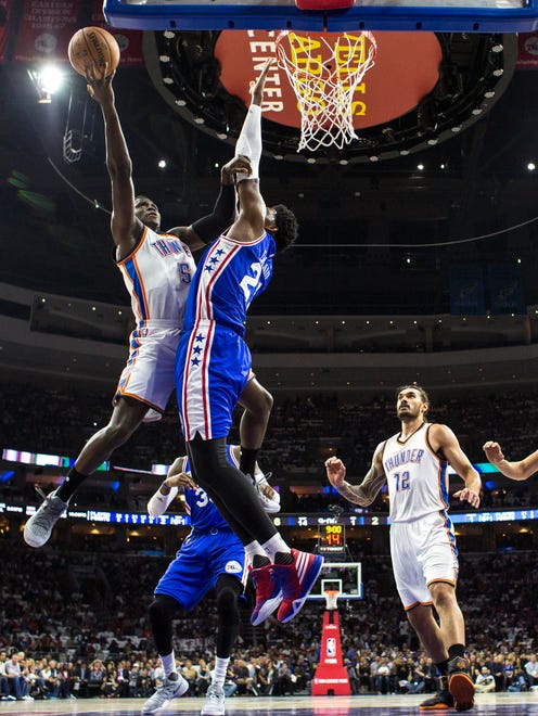 Victor Oladipo goes up for a shot over Joel Embiid.