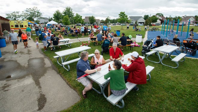 Members of the community gather for food, drink and live music during the Waukesha Neighborhood Beer Gardens event in Rivers Crossing Park on Thursday, August 17, 2017.