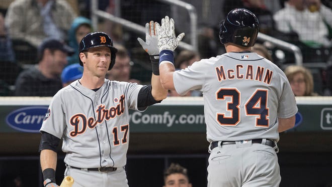 Tigers catcher James McCann (34) celebrates with shortstop Andrew Romine (17) after hitting a home run in the sixth inning of the Tigers' 6-3 loss Friday in Minneapolis.