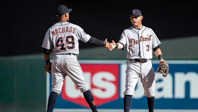 Tigers second baseman Ian Kinsler (3) celebrates with shortstop Dixon Machado (49) after the Tigers' 5-4 win over the Twins Saturday in Minneapolis.