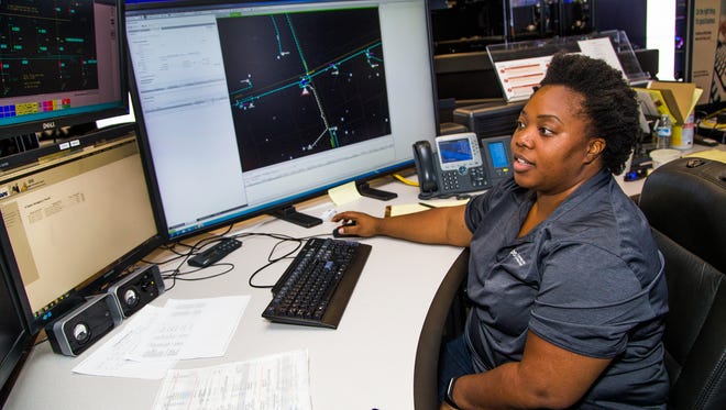 Dispatcher LaTanya Pouncey looks for problems on the electrical grid so she can dispatch Arizona Public Service repair teams. Pouncey works in the APS Distribution Operation Center in Phoenix, Monday, June 19, 2017.