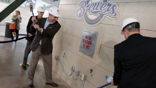 A ceremonial wall demolition took place on an old concession stand on the third base side in what will be the new third base ward. Taking part were Brewers Chief Operating Officer Rick Schlesinger (from left); John Sergi, the co-owner of Howard and Sergi, a hospitality design consultant; and Ken Gaber, general manager with food services Delaware North.