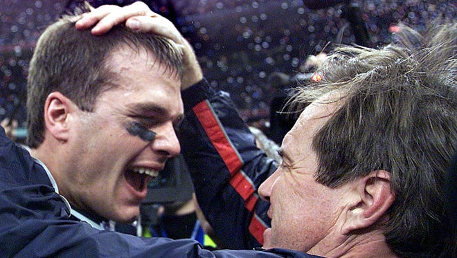 Brady celebrates with head coach Bill Belichick (R) after their win over the St. Louis Rams 03 February, 2002 in Super Bowl XXXVI in New Orleans, Louisiana. The Patriots defeated the Rams 20-17.