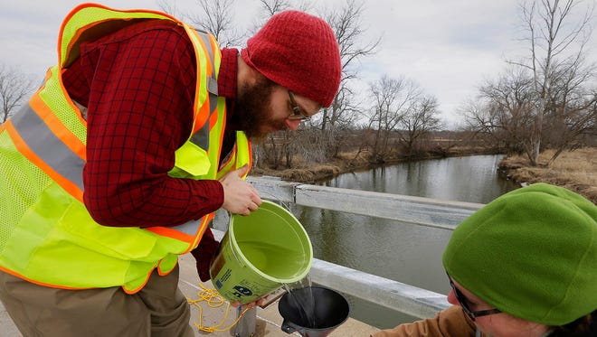 Josh Carlson student, left, and Laura Schulz, employed by  UW-Parkside, join others as  Parkside students collect water samples from Root River near South 60th and Oakwood Road in Franklin, Thursday, February 16, 2017. The University has been hired to sample water for The City of Waukesha's $207 million project to switch to Lake Michigan as a source of drinking water.
Testing the Root River water samples helps to better understand the river's current water quality. The city will discharge its fully treated wastewater to the river when it switches to the lake as it's water source.