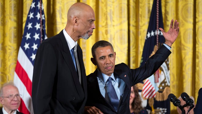 President Barack Obama pretends to skyhook as he awards former basketball player Kareem Abdul-Jabbar the Presidential Medal of Freedom.