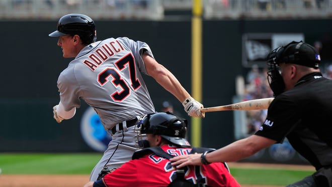 Jim Adduci of the Tigers hits a two-run double as Jason Castro of the Minnesota Twins catches the game during the third inning April 23, 2017 at Target Field in Minneapolis.