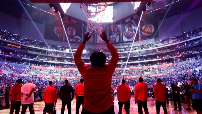 DeAndre Jordan grabs on the net before a game against the Jazz.