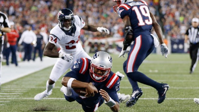 New England Patriots quarterback Jacoby Brissett (7) rushes for a touchdown during the first quarter against the Houston Texans at Gillette Stadium.