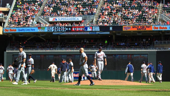 Players on the Minnesota Twins and the Detroit Tigers retreat to their positions after benches cleared in the fifth inning April 22, 2017 at Target Field in Minneapolis.