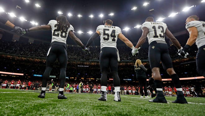 New Orleans Saints and Atlanta Falcons players form a unity demonstration on the field before an NFL football game in New Orleans, Monday, Sept. 26, 2016.