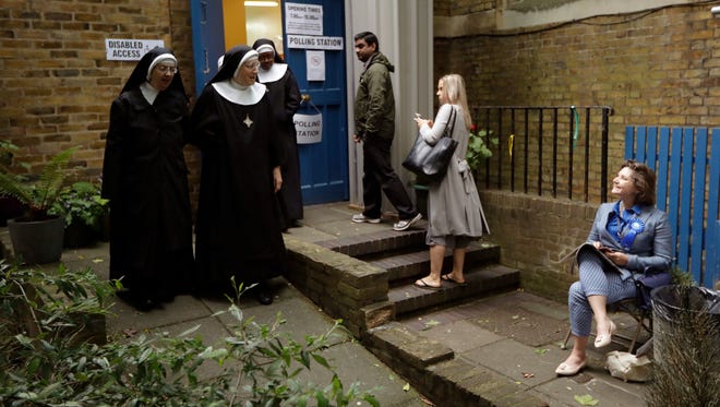 Benedictine nuns from Tyburn Convent leave after voting in Britain's general election at a polling station in St. John's Parish Hall, London, on June 8, 2017.