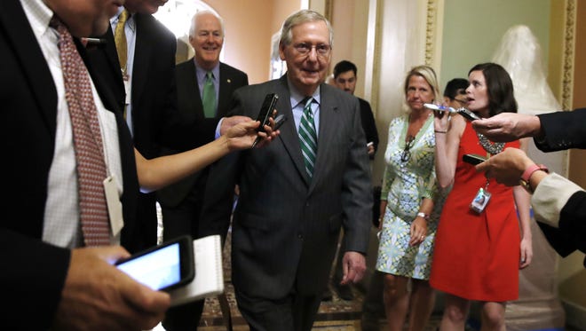 Senate Majority Leader Mitch McConnell, followed by Majority Whip John Cornyn, leaves a Republican meeting on health care on June 22, 2017, on Capitol Hill.