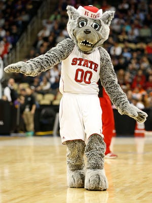 North Carolina State Wolfpack mascot "Mr Wuf" dances on the court during a game against LSU.