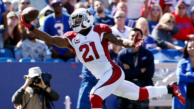 Cardinals cornerback Patrick Peterson hauls in an acrobatic one-handed interception during the first half against the Bills.