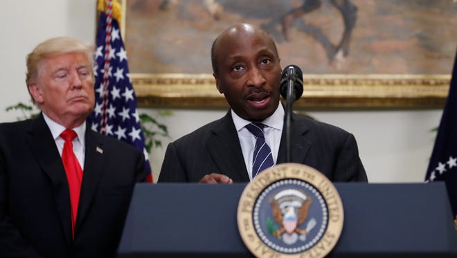 Ken Frazier, chairman and chief executive officer of Merck speaks, with President Donald Trump at left, during an event to announce a Merck, Pfizer, and Corning joint partnership to make glass containers for medication, in the Roosevelt Room of the White House on  July 20, 2017, in Washington. Merck CEO Ken Frazier quit President Trump's manufacturing jobs council on Aug 14, 2017, following the president's widely criticized response to violence that erupted after a neo-Nazi rally in Charlottesville over the weekend.