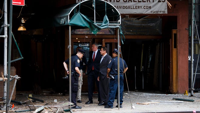 New York Mayor Bill de Blasio, 3rd from left, and New York Gov. Andrew Cuomo, second from right,  tour the site of an explosion that occurred overnight in the Chelsea neighborhood of New York.