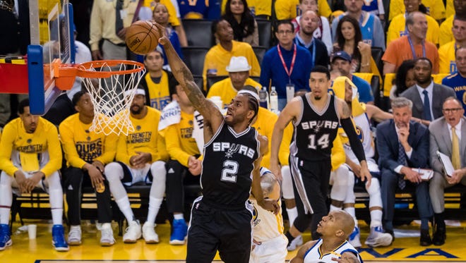 San Antonio Spurs forward Kawhi Leonard dunks the ball against the Golden State Warriors during the second quarter in Game 1 of the Western Conference finals.