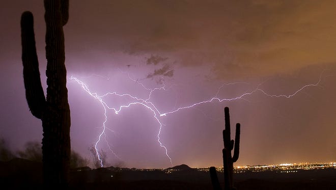 Lightning strikes over the East Valley during a monsoon storm viewed from Fountain Hills in 2009.