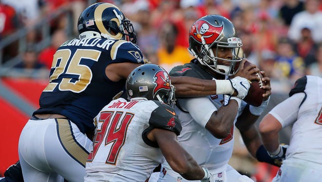 Buccaneers quarterback Jameis Winston (3) is tackled by Rams safety T.J. McDonald (25).