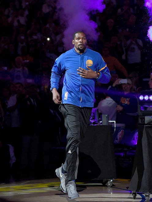 Kevin Durant runs onto the court during player introduction prior to his Warriors debut.