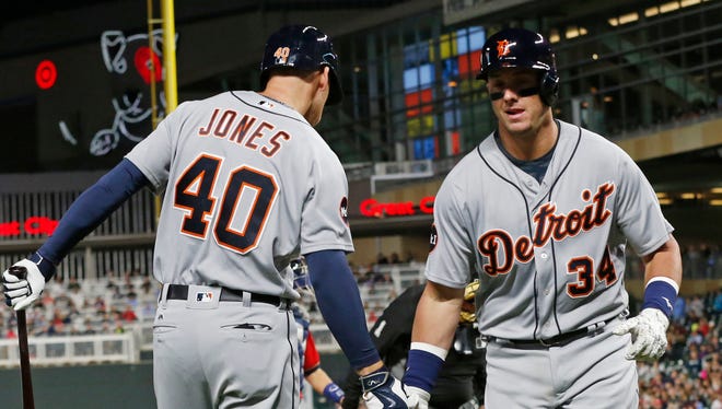 Tigers catcher James McCann, right, is congratulated by JaCoby Jones on his solo home run off during the sixth inning of the Tigers' 6-3 loss Friday in Minneapolis.