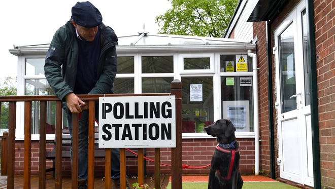 A voter ties up Guia, a Labrador rescued from Ecuador, outside a polling station in Stalybridge in greater Manchester. Britain went to the polls on June 8, 2017, in a snap election to choose who will lead the country out of the European Union, after a campaign overshadowed by terrorist attacks.