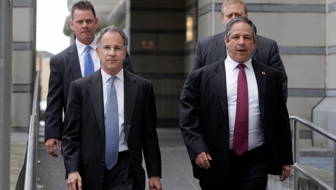 United States Attorney for the District of New Jersey, Paul J. Fishman, front left, walks from federal court after a hearing for David Wildstein  Friday, May 1, 2015, in Newark, N.J. Wildstein,, a former ally of Gov. Chris Christie pleaded guilty Friday to helping engineer traffic jams at the George Washington Bridge in a political payback scheme he said also involved two other Christie loyalists. But he did not publicly implicate Christie himself. (AP Photo/Mel Evans)