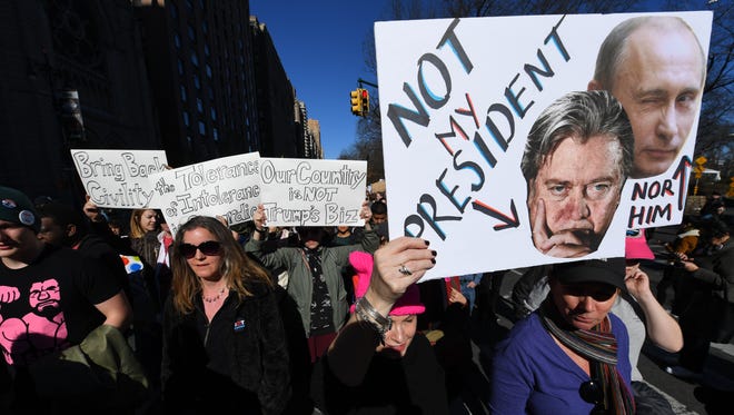 Protestors march along Central Park South during the 'Not My Presidents Day' rally in New York.