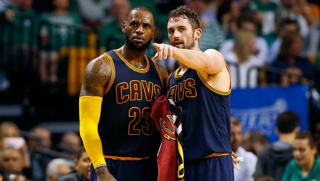 Cleveland Cavaliers forward Kevin Love (0) talks with forward LeBron James (23) during the second half against the Boston Celtics in Game 2 of the Eastern Conference finals.