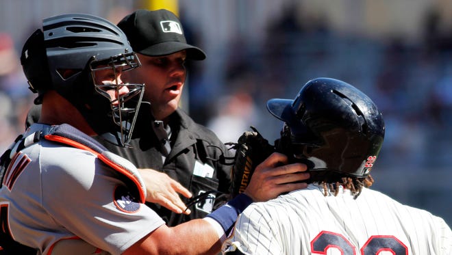 Miguel Sano of the Twins and James McCann of the Tigers clash with home plate umpire Jordan Baker attempting to break up the altercation in the fifth inning April 22, 2017 in Minneapolis. Sano and Tigers pitcher Boyd were ejected from the game.