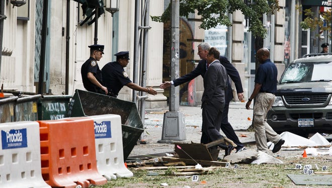 New York Mayor Bill de Blasio,rear, and New York Gov. Andrew Cuomo, second from right, tour the site of an explosion that occurred in the Chelsea neighborhood of New York City.