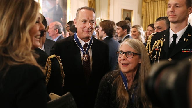 Actor, filmmaker and social justice advocate Tom Hanks, center, and NASA mathematician and computer software pioneer Margaret Hamilton, second from right,  leave an East Room ceremony where they were awarded the Presidential Medal of Freedom.