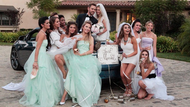 Nick Viall takes a group of women on a date posing for wedding photos.