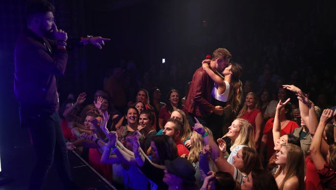 Viall and Danielle L. dance in the middle of the crowd while Chris Lane performs.