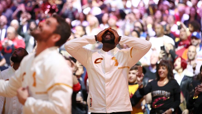 LeBron James reacts during the championship banner raising and ring ceremony.