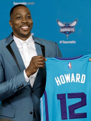 Charlotte Hornets' Dwight Howard poses for a photo holding his new jersey during an NBA basketball news conference in Charlotte, N.C., Monday, June 26, 2017.