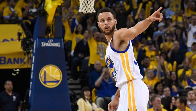 Golden State Warriors guard Stephen Curry celebrates against the San Antonio Spurs during the first quarter in Game 2 of the Western Conference finals.
