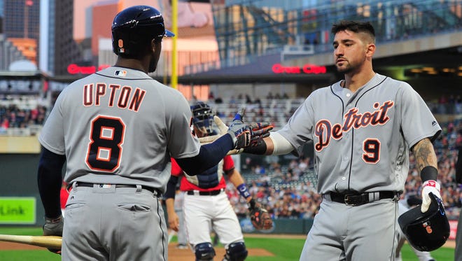 Tigers leftfielder Justin Upton congratulates teammate Nick Castellanos scoring a run during the third inning Friday in Minneapolis.