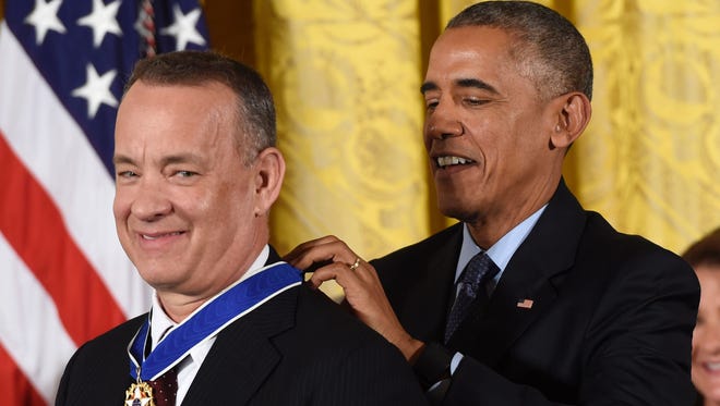 US President Barack Obama presents actor Tom Hanks with the Presidential Medal of Freedom, the nation's highest civilian honor.