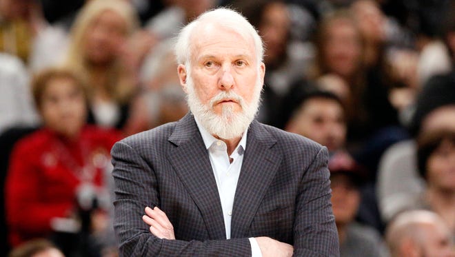 San Antonio Spurs head coach Gregg Popovich watches from the sidelines against the Milwaukee Bucks during the first half at AT & T Center.