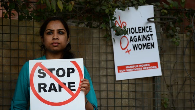 This file photo taken on Feb. 21, 2017 shows an Indian social activist holding a placard during a protest against a rape at Hauz Khas village in New Delhi.