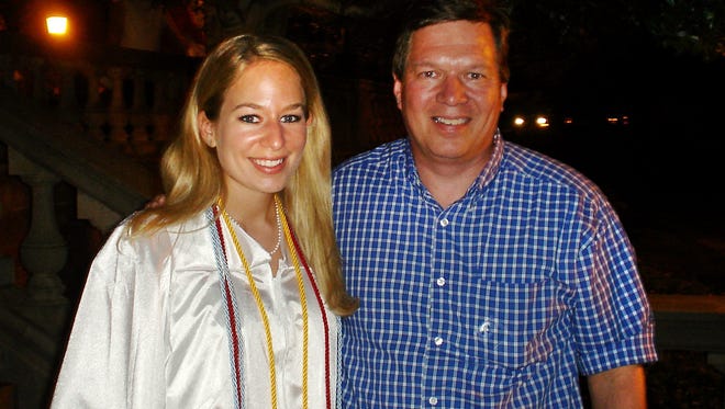 In this handout photo provided by Beth Twitty, Natalee Holloway (left) stands with her father Dave Holloway on her graduation day from Mountain Brook High School in Mountain Brook, Ala., in 2005.