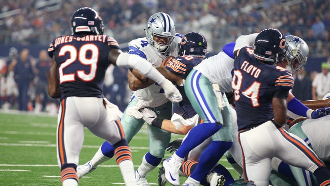 Cowboys quarterback Dak Prescott (4) scores a touchdown in the first quarter against the Chicago Bears.