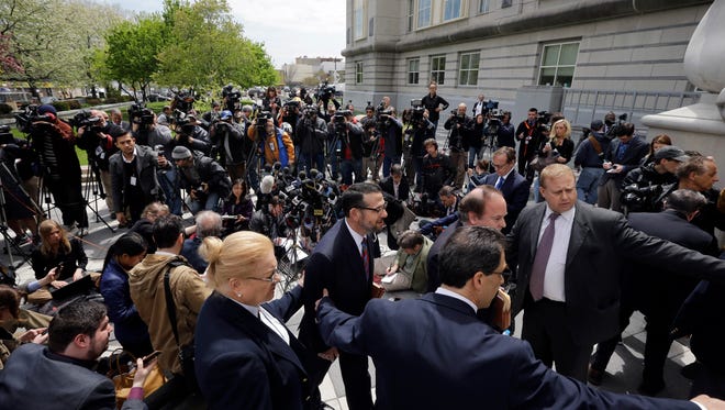 David Wildstein, center, walks with his attorney Alan Zegas, center right partially blocked after Zegas addressed the media outside federal court after a hearing Friday, May 1, 2015, in Newark, N.J. Wildstein,, a former ally of Gov. Chris Christie pleaded guilty Friday to helping engineer traffic jams at the George Washington Bridge in a political payback scheme he said also involved two other Christie loyalists. But he did not publicly implicate Christie himself.(AP Photo/Mel Evans)