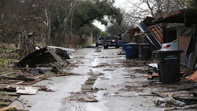 Debris scatters an alley after severe storms moved though the Camelot subdivision of Northeast Bexar County, Texas on Feb. 20, 2017.