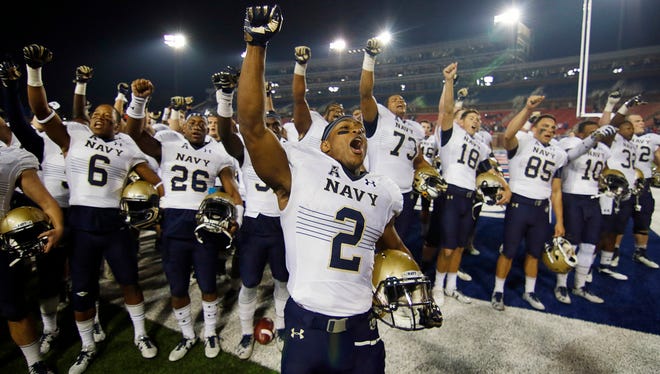 Navy running back Toneo Gulley leads the cheer following the Midshipmen's 75-31 victory over the SMU Mustangs at Gerald J. Ford Stadium on Nov. 26.